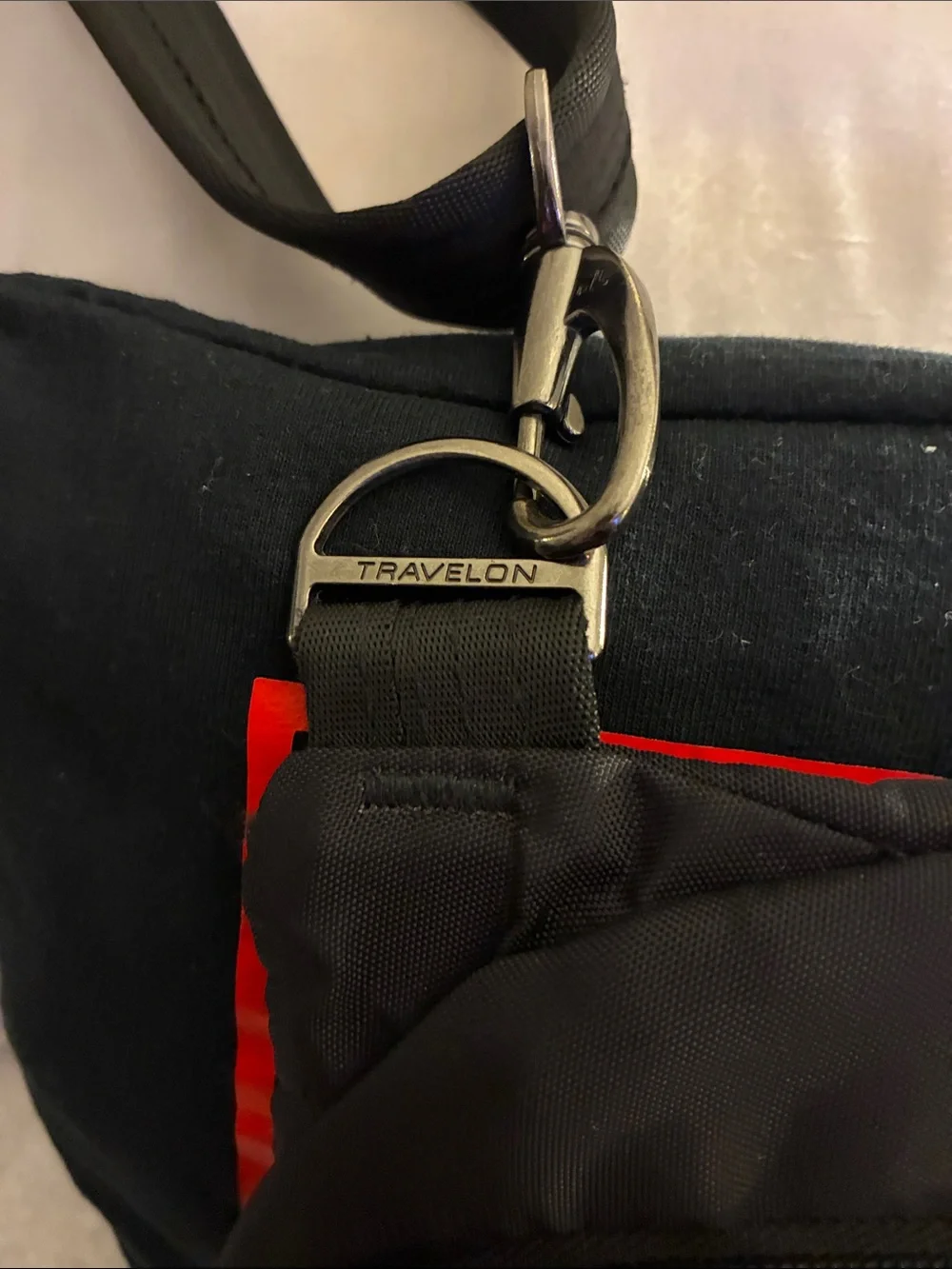 Travelon Black Sling Backpack with Red Accent